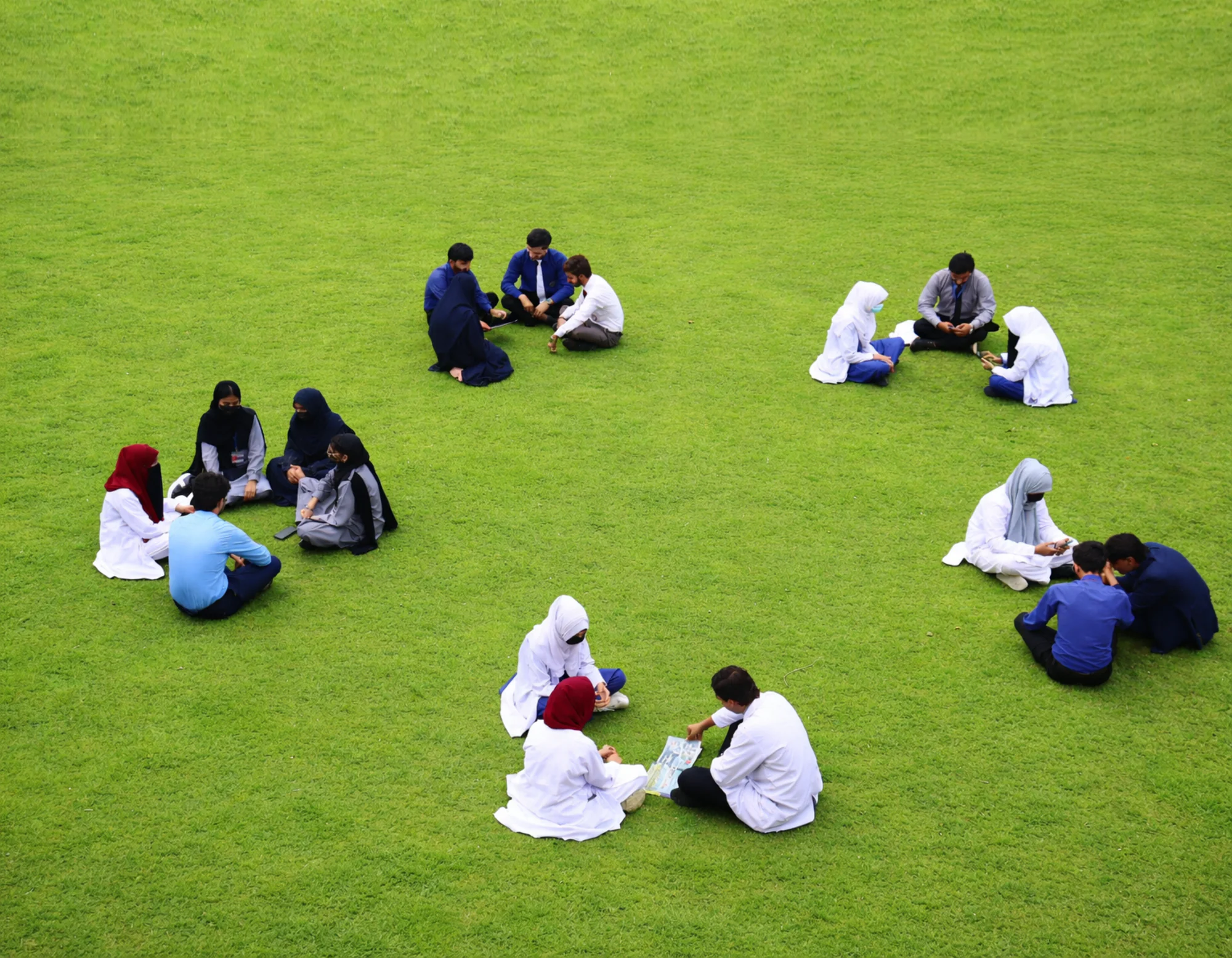Students on the ONIMS campus lawn between classes